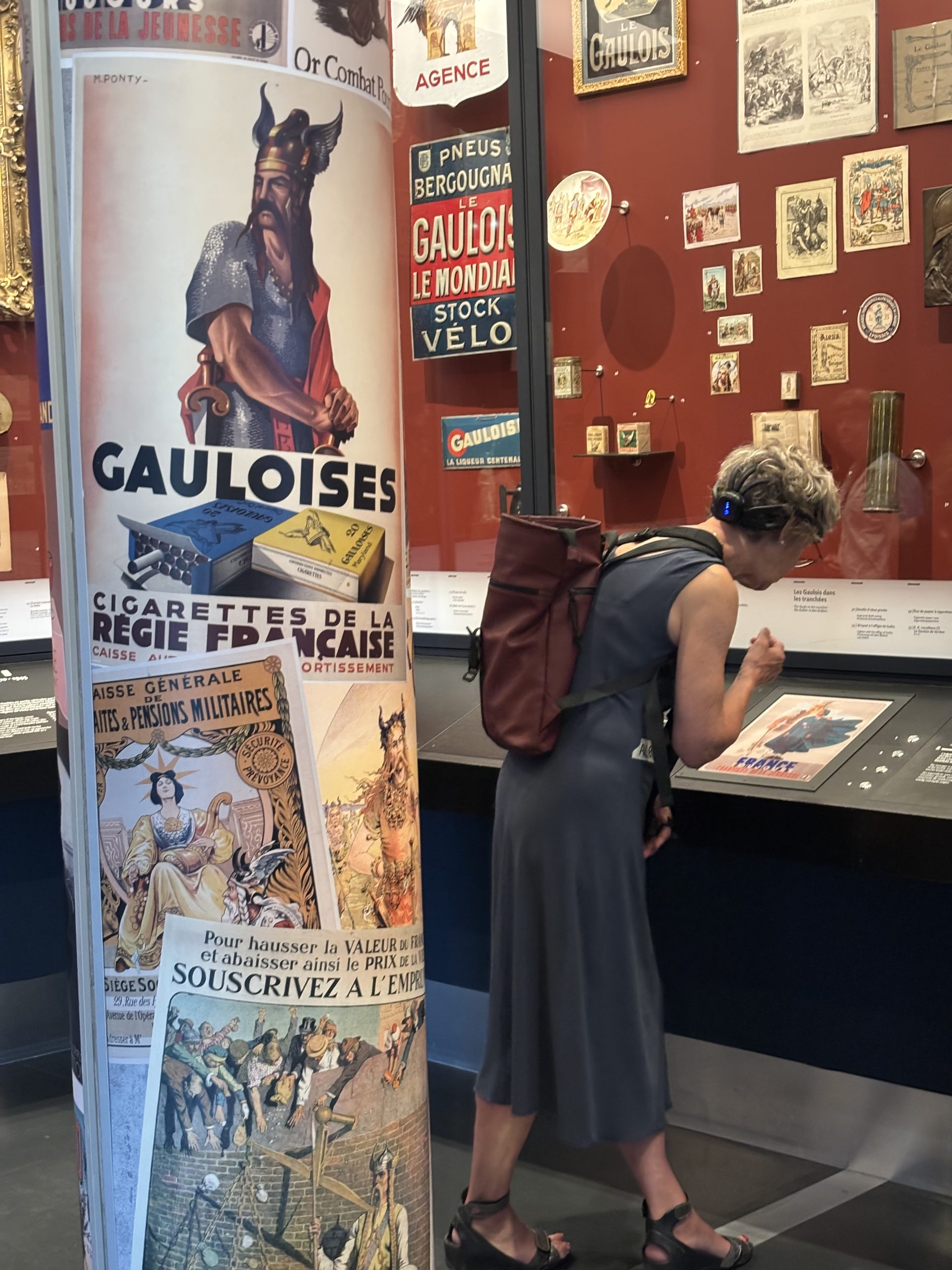 a woman taking a closer look at a museum display.